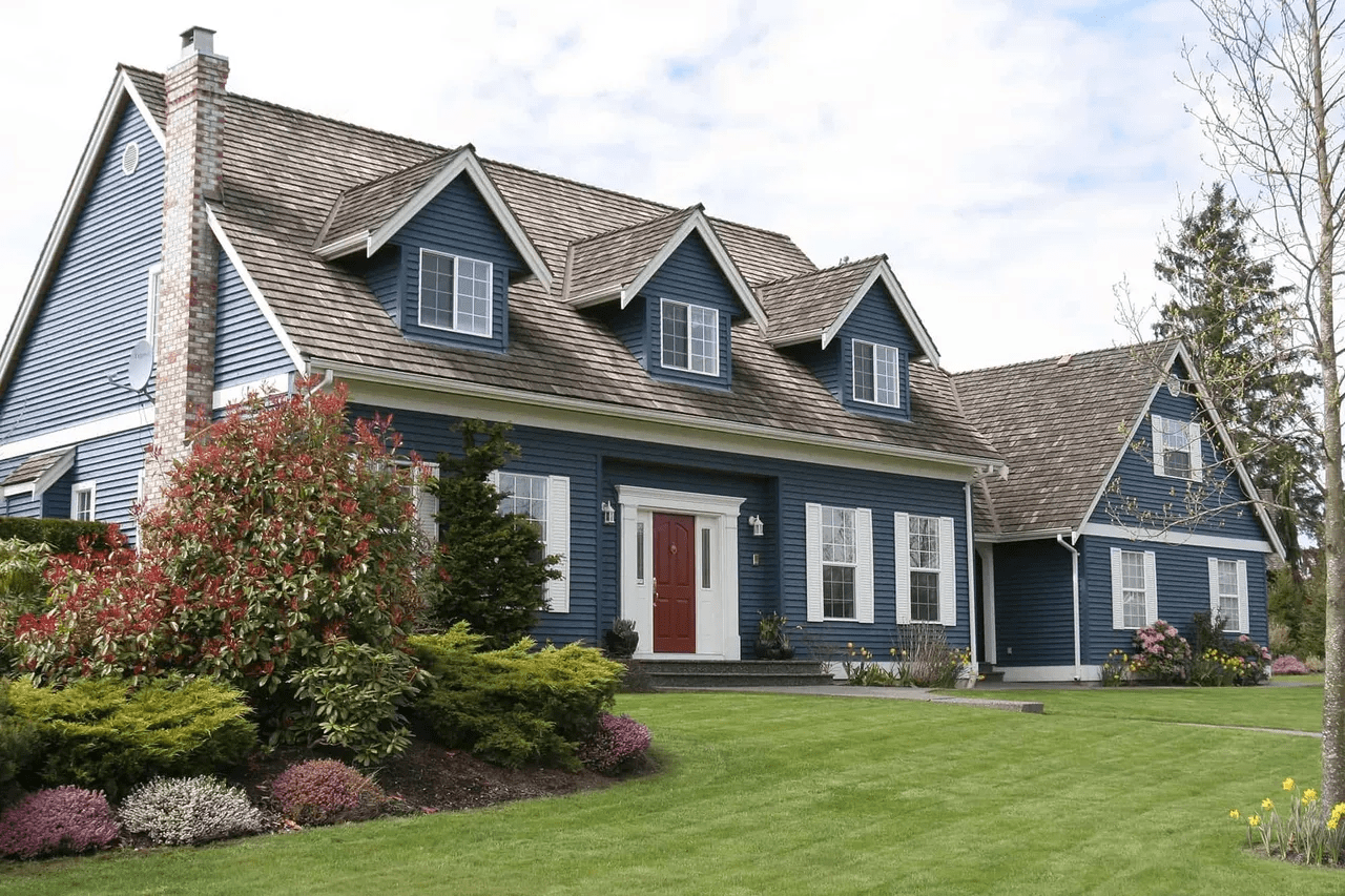 Blue house with red door and garden