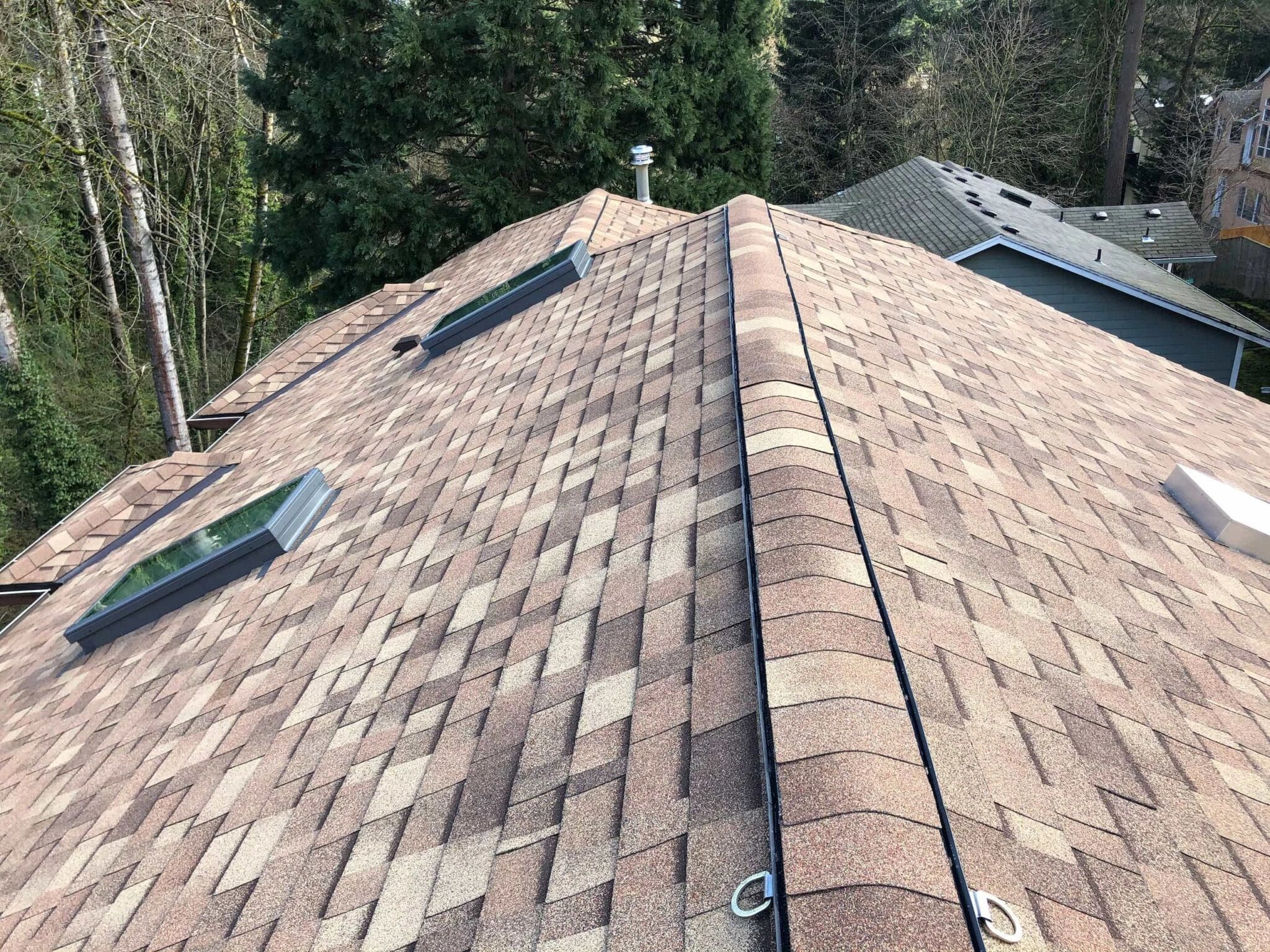 A roofing contractor performing roof repairs on a residential property.